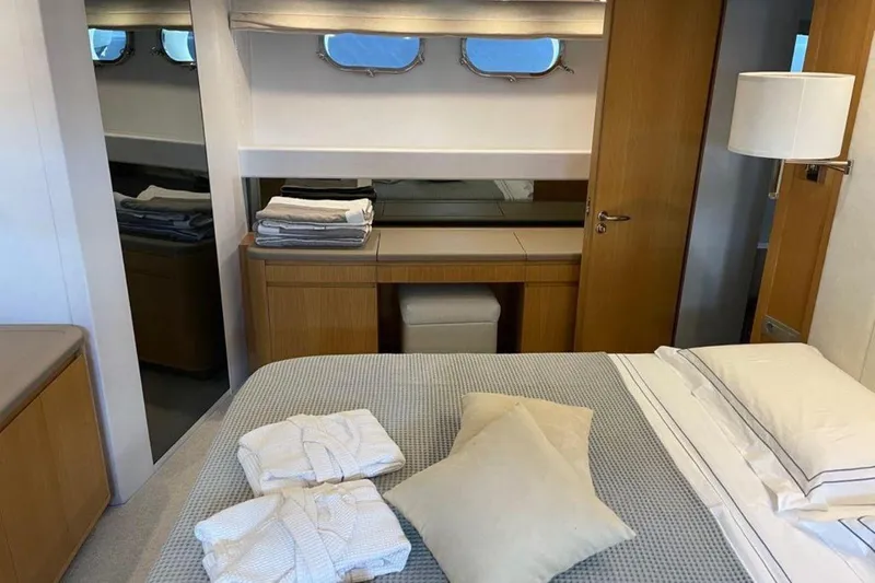  Yacht Photos Pics Luxurious cabin interior of 2010 Sanlorenzo SL72 yacht with elegant bedding and wooden furnishings.
