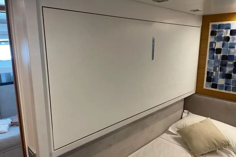  Yacht Photos Pics Interior of 2010 Sanlorenzo SL72 yacht cabin with modern wall decor and bed.