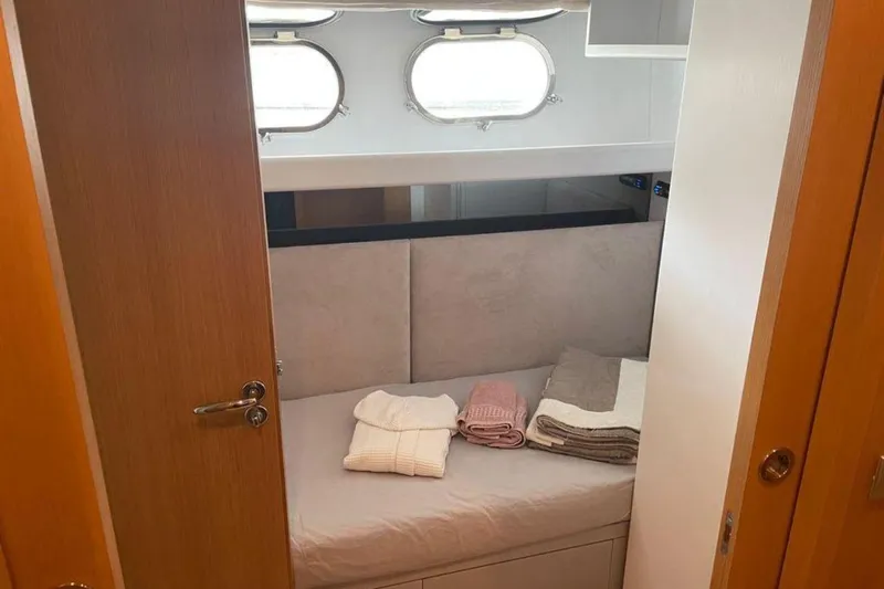  Yacht Photos Pics Cozy cabin interior of 2010 Sanlorenzo SL72 yacht with neatly folded towels.