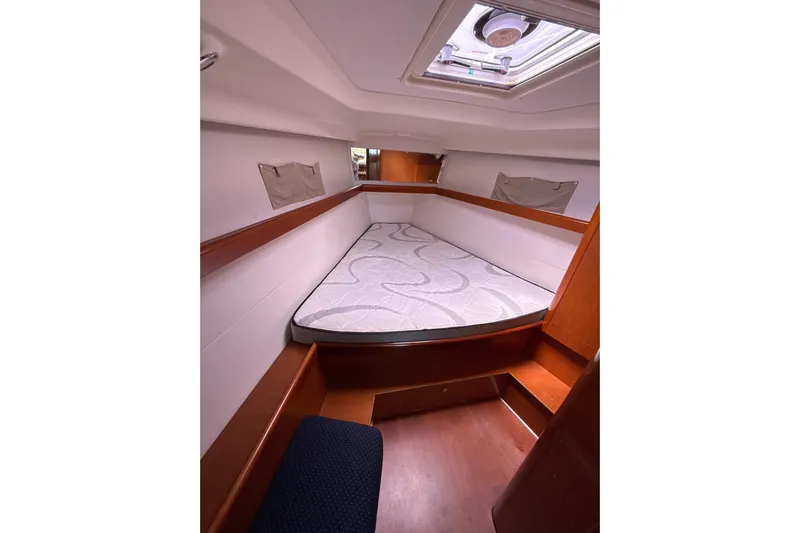 Vision 360 Yacht Photos Pics Interior cabin of 2012 Beneteau First 435 sailboat with cozy bed and wooden finish.