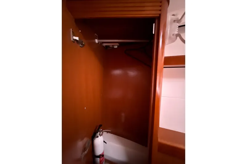Vision 360 Yacht Photos Pics Wooden closet interior on 2012 Beneteau First 435 yacht with fire extinguisher.