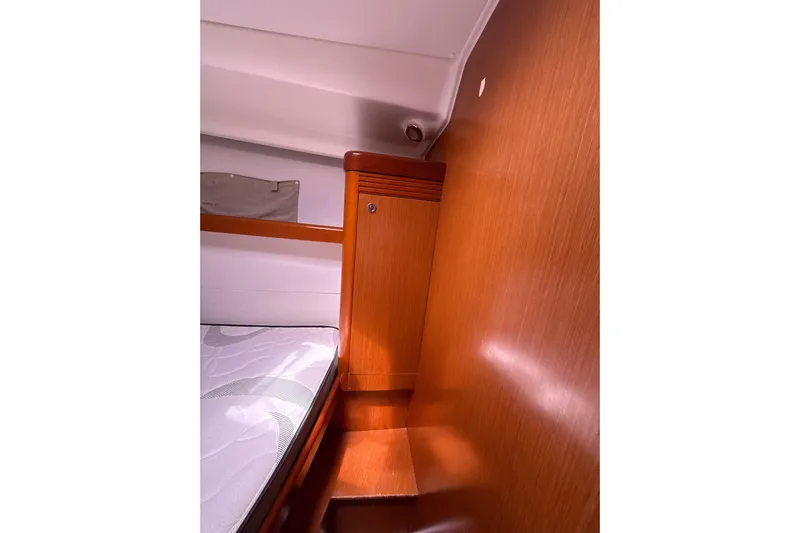 Vision 360 Yacht Photos Pics Interior cabin of 2012 Beneteau First 435 yacht with wooden paneling and bed.