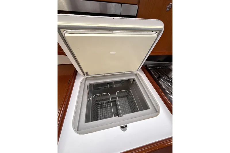 Vision 360 Yacht Photos Pics Open storage compartment in 2012 Beneteau First 435 yacht kitchen area.