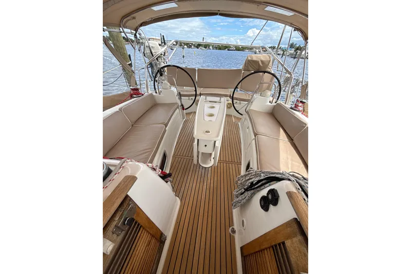 Vision 360 Yacht Photos Pics Beneteau First 435 sailboat cockpit with dual steering wheels, teak flooring, and beige seating, 2012 model.