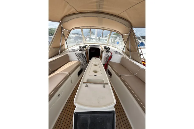 Vision 360 Yacht Photos Pics Interior view of 2012 Beneteau First 435 sailboat with beige seating and canopy.