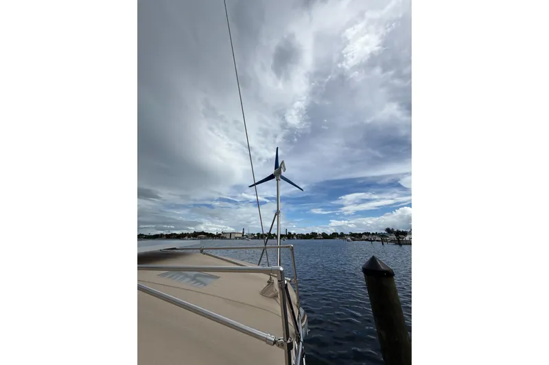 Vision 360 Yacht Photos Pics Beneteau First 435 sailboat with wind turbine, docked under cloudy sky, 2012 model.