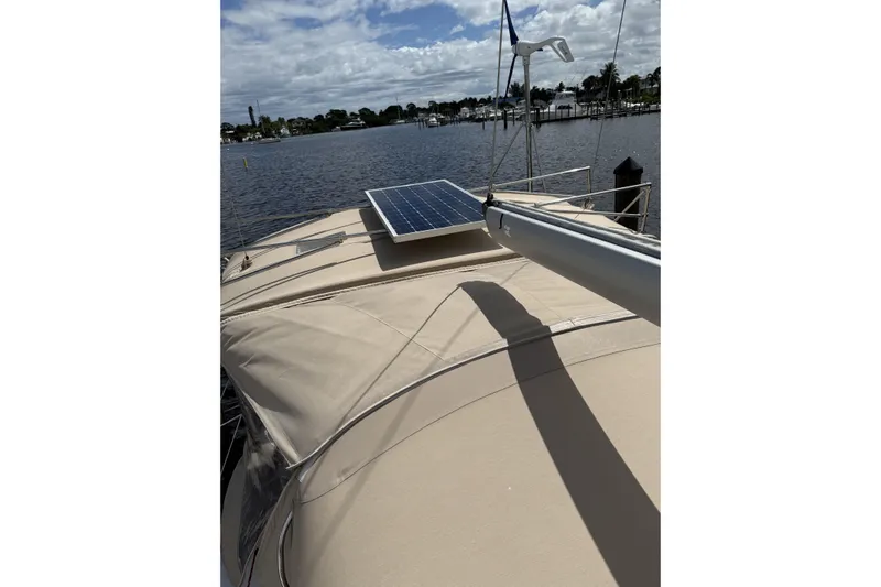 Vision 360 Yacht Photos Pics Beneteau First 435 sailboat with solar panel, docked by a scenic waterfront, 2012 model.