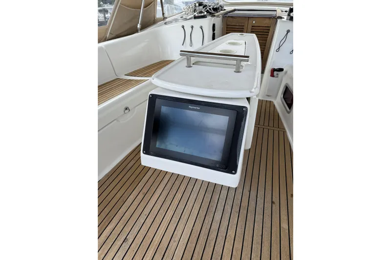 Vision 360 Yacht Photos Pics Beneteau First 435 yacht cockpit with navigation display, teak flooring, and seating, 2012 model.