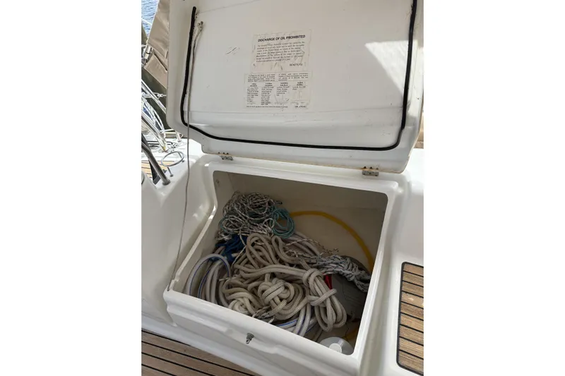 Vision 360 Yacht Photos Pics Open storage compartment on 2012 Beneteau First 435 sailboat, containing ropes and equipment.