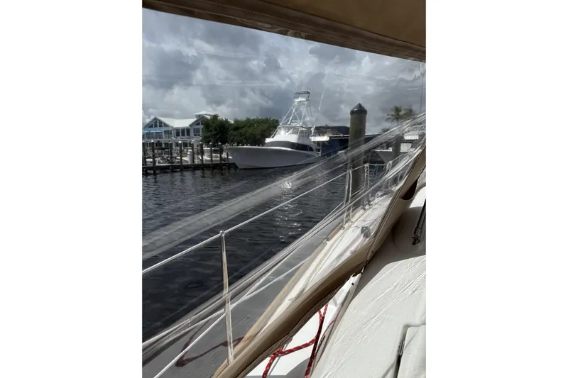 Vision 360 Yacht Photos Pics Beneteau First 435 sailboat docked, view through clear canopy, cloudy sky, marina background.