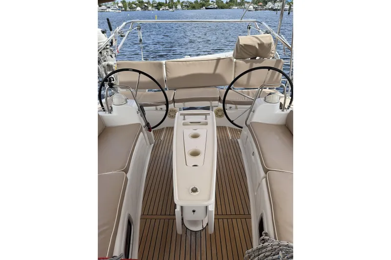 Vision 360 Yacht Photos Pics Beneteau First 435 sailboat cockpit with dual steering wheels, teak flooring, and beige seating, 2012 model.