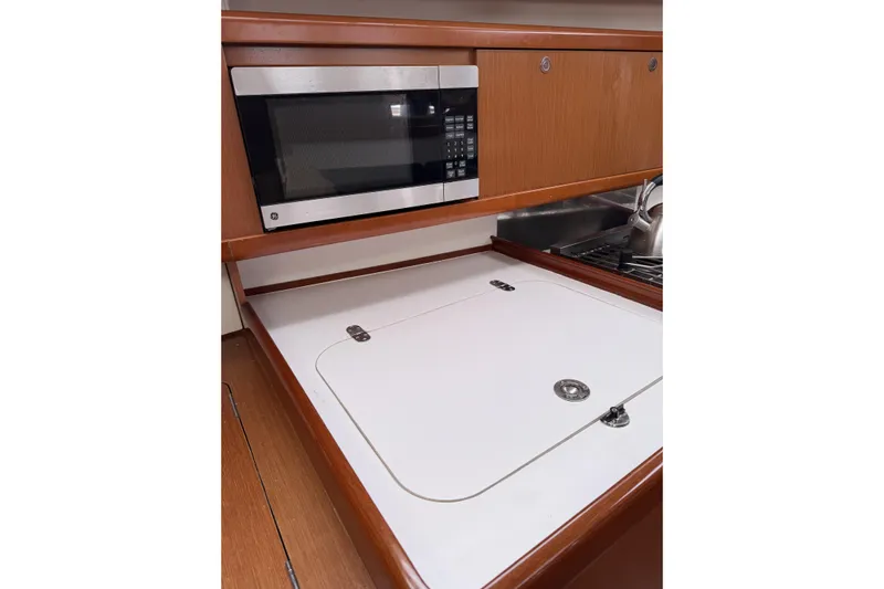Vision 360 Yacht Photos Pics Beneteau First 435 2012 yacht kitchen with microwave and wooden cabinetry.