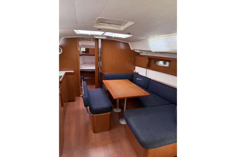 Vision 360 Yacht Photos Pics Interior of 2012 Beneteau First 435 yacht with wooden furnishings and cozy seating area.