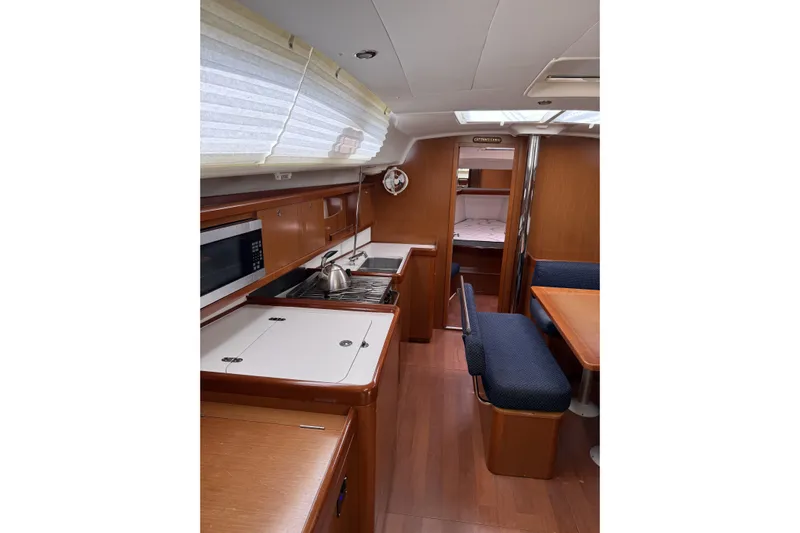 Vision 360 Yacht Photos Pics Interior of 2012 Beneteau First 435 yacht with kitchen and seating area.
