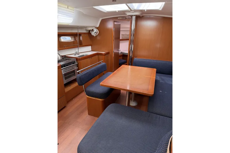 Vision 360 Yacht Photos Pics Interior of 2012 Beneteau First 435 yacht with wooden furnishings and blue seating.