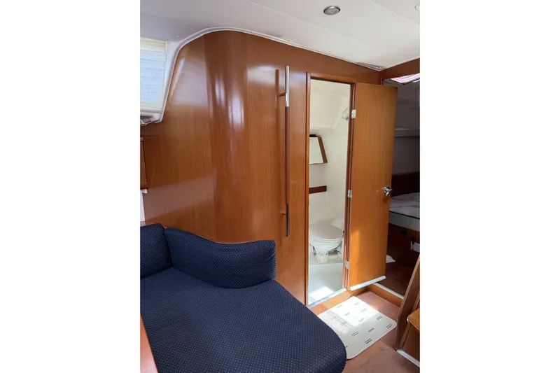 Vision 360 Yacht Photos Pics Interior of 2012 Beneteau First 435 yacht, featuring wooden paneling and a compact bathroom.