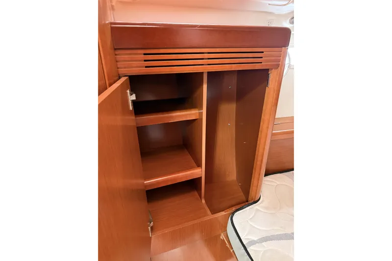 Vision 360 Yacht Photos Pics Wooden cabinet interior on 2012 Beneteau First 435 yacht, featuring shelves and open door.