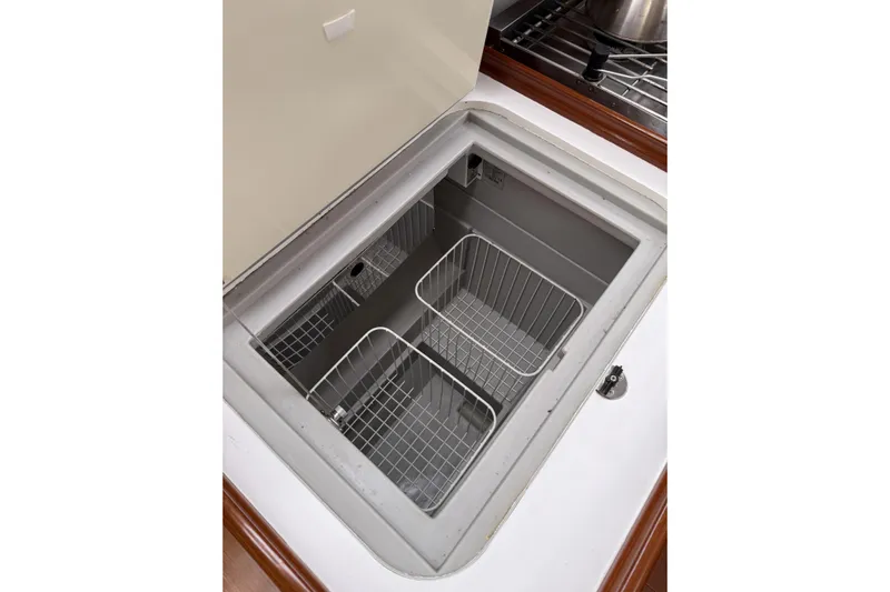 Vision 360 Yacht Photos Pics Built-in storage compartment on a 2012 Beneteau First 435 yacht, featuring wire baskets.
