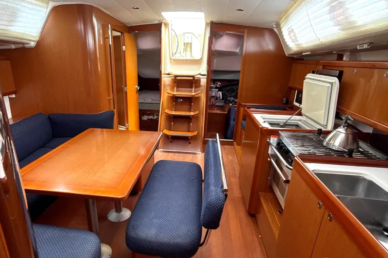 Vision 360 Yacht Photos Pics Interior of 2012 Beneteau First 435 yacht with wooden furnishings and compact kitchen.