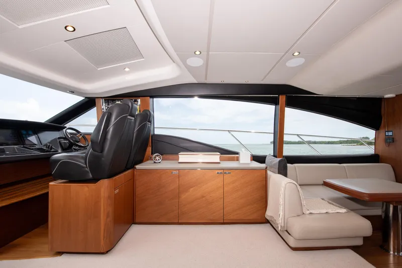 Wheelhouse Yacht Photos Pics Luxurious interior of 2021 Princess S66 yacht with modern seating and helm station.