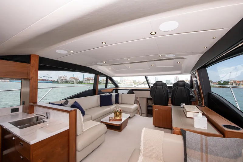 Wheelhouse Yacht Photos Pics Luxurious interior of 2021 Princess S66 yacht with modern seating and panoramic windows.