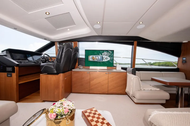 Wheelhouse Yacht Photos Pics Luxurious interior of 2021 Princess S66 yacht with elegant seating and helm station.