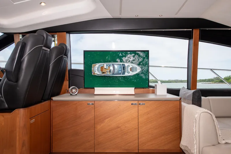 Wheelhouse Yacht Photos Pics Interior of 2021 Princess S66 yacht with modern design and large screen display.