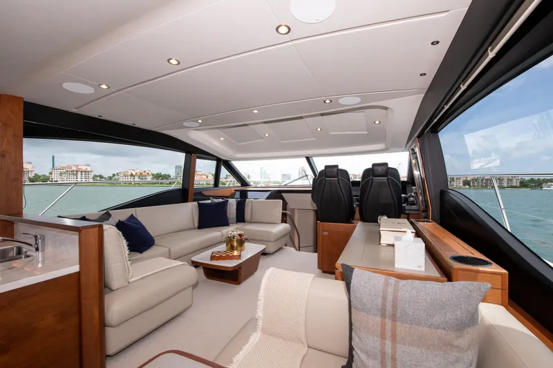 Wheelhouse Yacht Photos Pics Luxurious interior of 2021 Princess S66 yacht with elegant seating and panoramic windows.