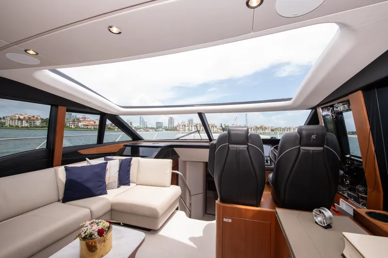 Wheelhouse Yacht Photos Pics Luxurious interior of 2021 Princess S66 yacht with panoramic windows and elegant seating.