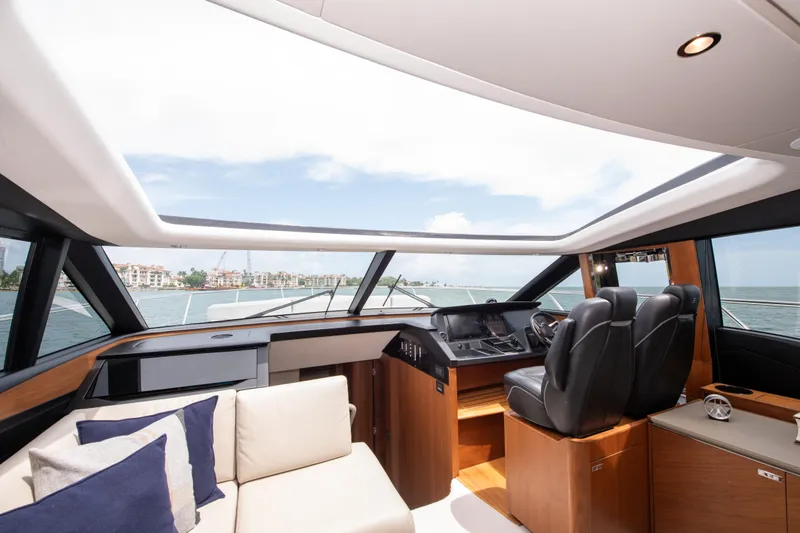 Wheelhouse Yacht Photos Pics Luxurious interior of 2021 Princess S66 yacht with modern helm and comfortable seating.