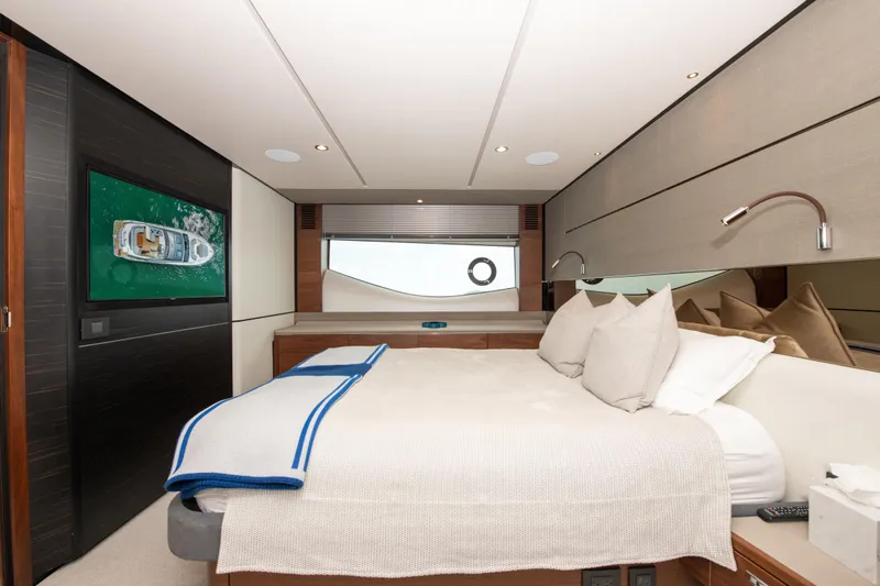Wheelhouse Yacht Photos Pics Luxurious 2021 Princess S66 yacht bedroom with modern decor and elegant bedding.