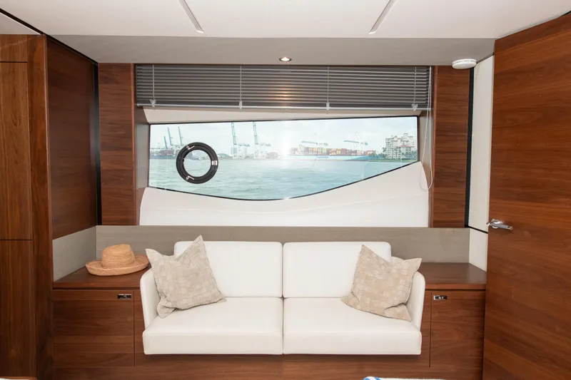 Wheelhouse Yacht Photos Pics Luxurious interior of 2021 Princess S66 yacht with white sofa and scenic window view.