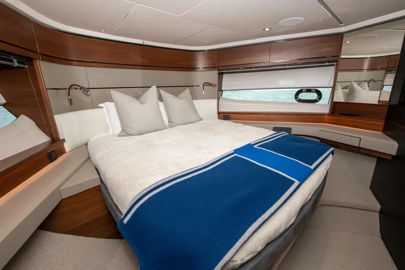 Wheelhouse Yacht Photos Pics Luxurious cabin interior of 2021 Princess S66 yacht with elegant bedding and modern design.