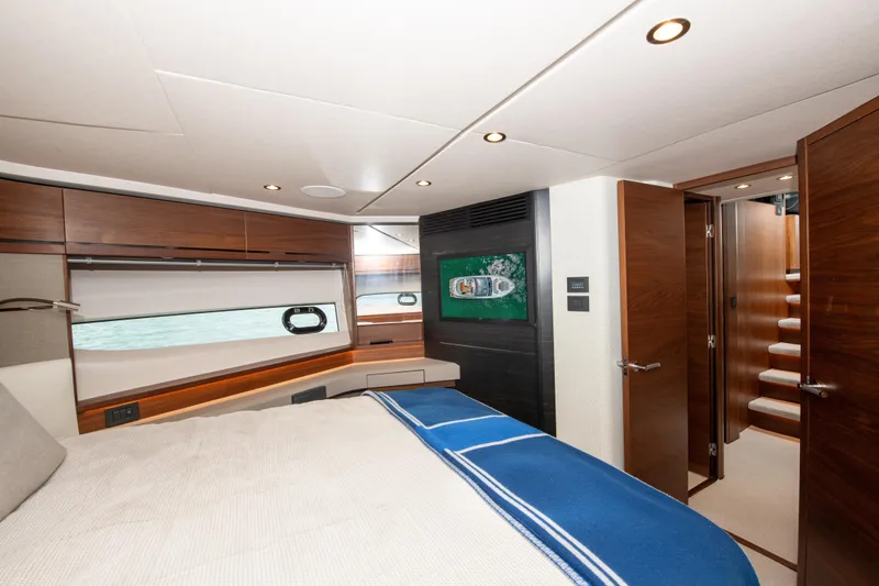 Wheelhouse Yacht Photos Pics Luxurious bedroom interior of 2021 Princess S66 yacht with modern design and elegant wood finishes.