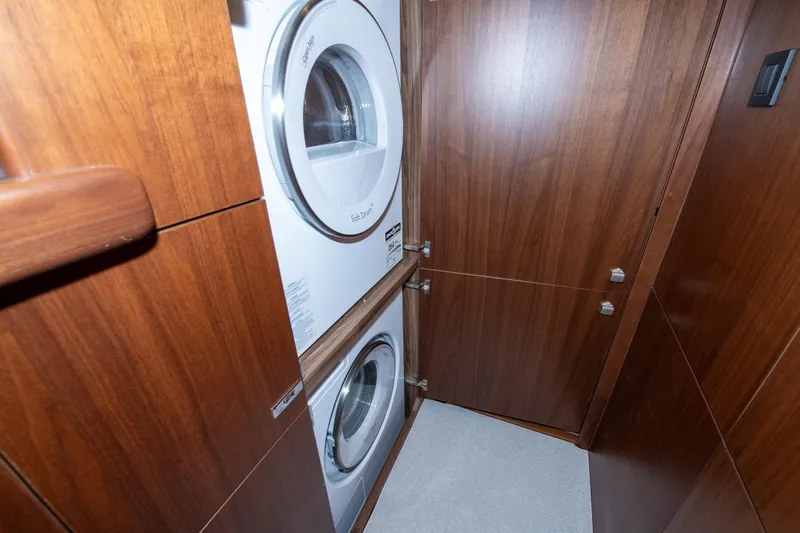 Wheelhouse Yacht Photos Pics Laundry area with stacked washer and dryer in 2021 Princess S66 yacht.