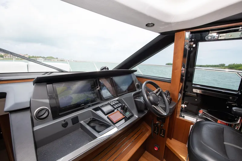 Wheelhouse Yacht Photos Pics Helm of 2021 Princess S66 yacht with modern controls and steering wheel.