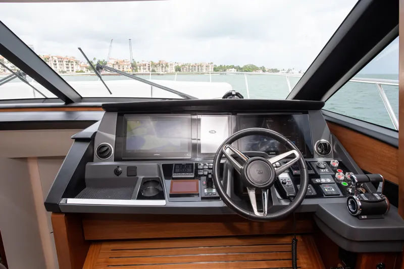 Wheelhouse Yacht Photos Pics Cockpit of 2021 Princess S66 yacht with modern navigation controls and steering wheel.