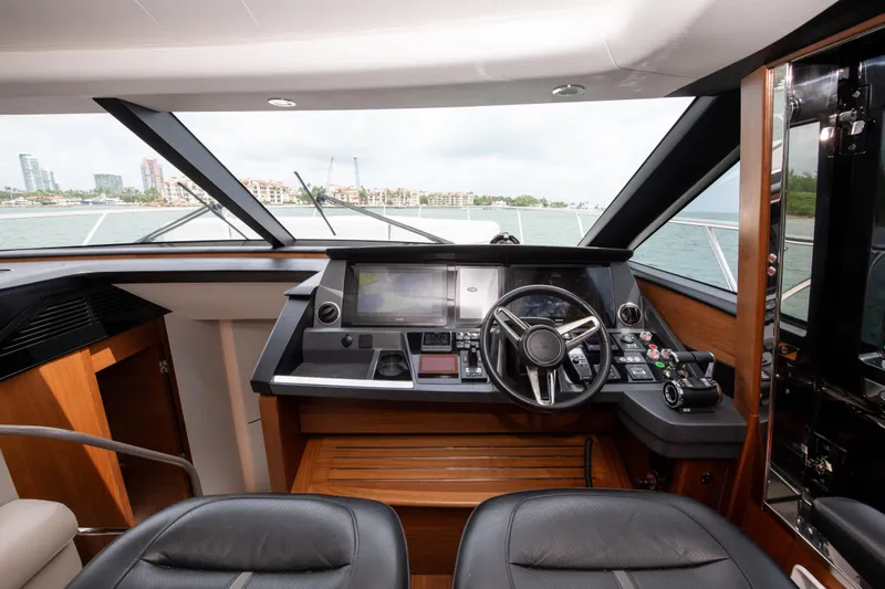Wheelhouse Yacht Photos Pics Luxurious 2021 Princess S66 yacht helm with modern navigation controls and panoramic windows.