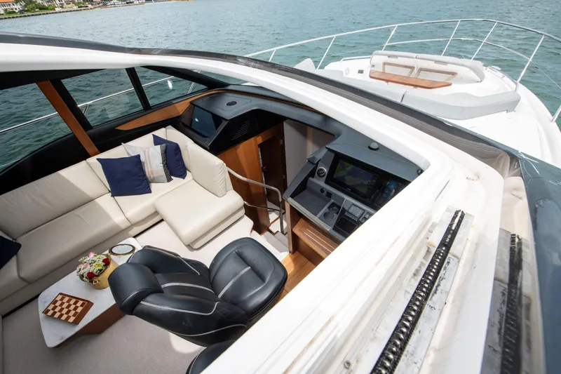 Wheelhouse Yacht Photos Pics Luxurious interior of 2021 Princess S66 yacht with seating and navigation area.