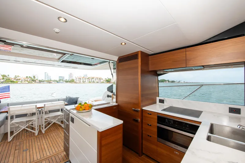 Wheelhouse Yacht Photos Pics Luxurious 2021 Princess S66 yacht interior with modern kitchen and scenic ocean view.
