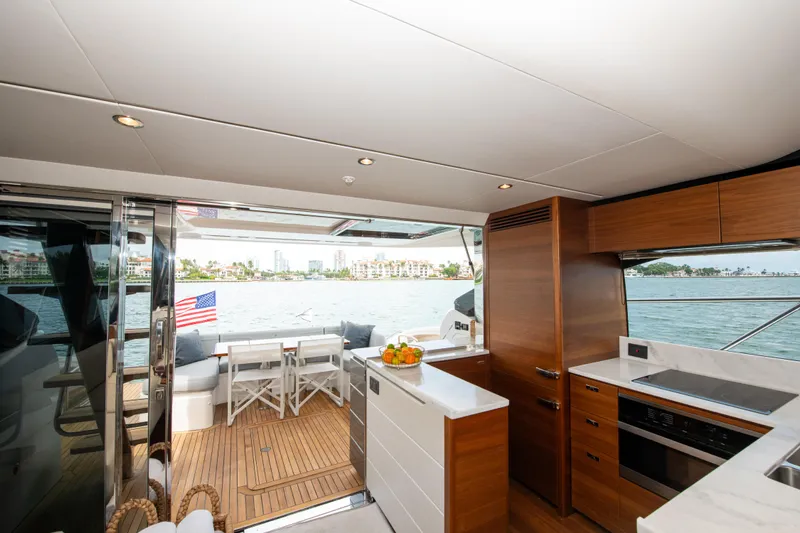 Wheelhouse Yacht Photos Pics Luxurious 2021 Princess S66 yacht interior with modern kitchen and scenic ocean view.