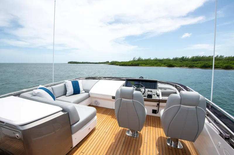 Wheelhouse Yacht Photos Pics Luxurious 2021 Princess S66 yacht interior with sleek seating and ocean view.