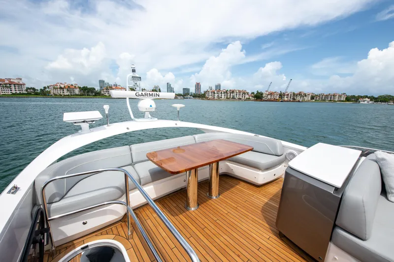 Wheelhouse Yacht Photos Pics Luxury Princess S66 yacht deck with seating, table, and ocean view, 2021 model.