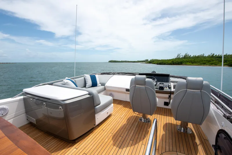 Wheelhouse Yacht Photos Pics Luxury Princess S66 yacht deck with seating, ocean view, and modern design, 2021 model.