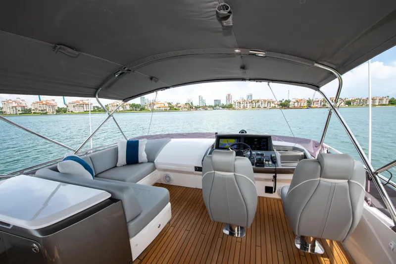 Wheelhouse Yacht Photos Pics Luxurious 2021 Princess S66 yacht interior with sleek seating and modern controls, overlooking scenic waterfront.