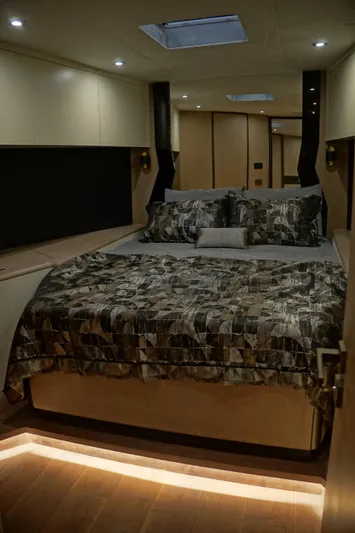  Yacht Photos Pics Luxurious bedroom interior in 2026 Phantom Spook Fly 62 yacht, featuring elegant bedding and ambient lighting.