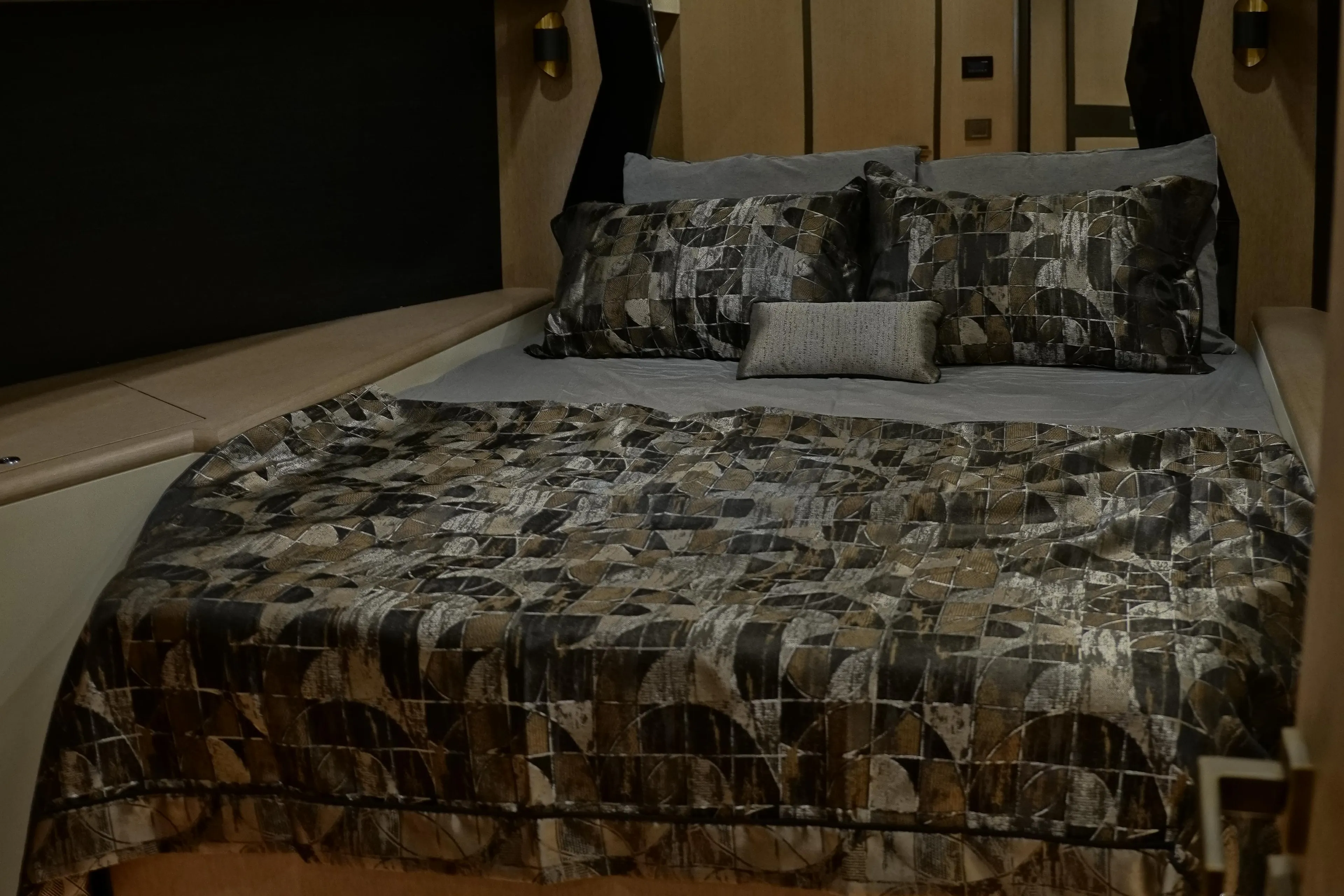 Luxurious bedroom in 2026 Phantom Spook Cabin Cruiser 62 yacht, featuring elegant bedding and ambient lighting.