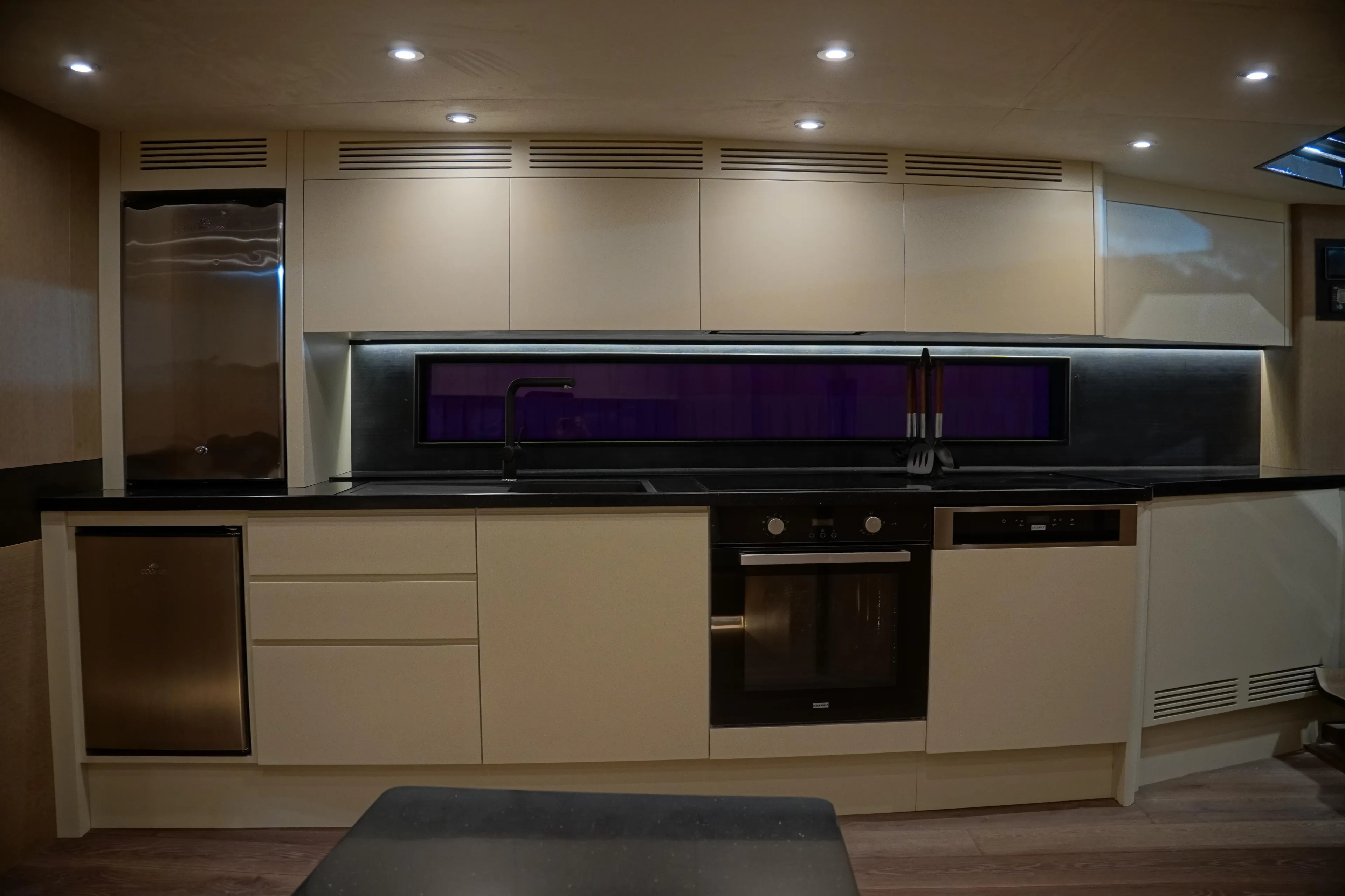 Modern kitchen interior in 2026 Phantom Spook Cabin Cruiser 62 yacht, featuring sleek cabinetry and appliances.