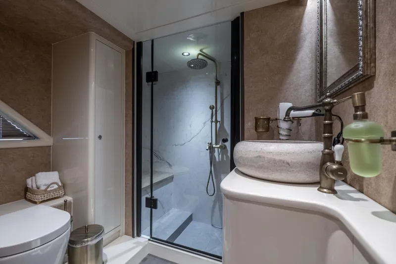  Yacht Photos Pics Luxurious bathroom in Phantom Spook Fly 62, 2026 model, featuring modern shower and elegant fixtures.