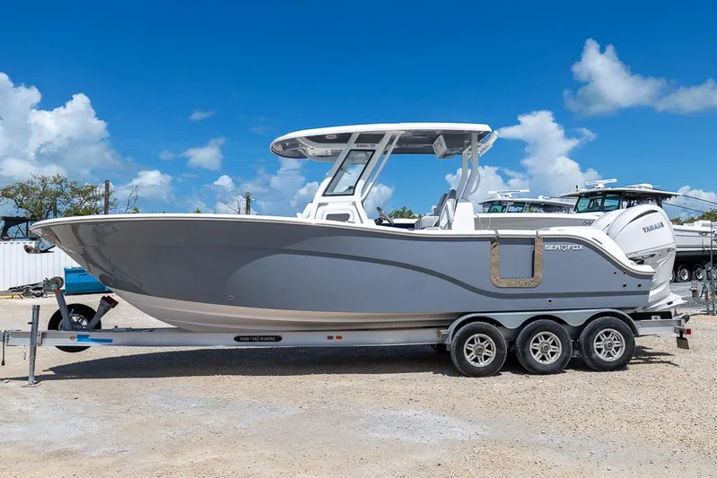  Yacht Photos Pics 2026 Sea Fox 288 Commander boat on trailer under clear blue sky.